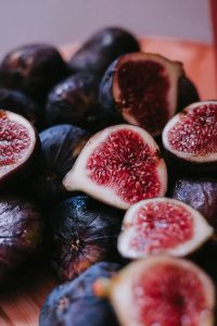 figues coupées en deux fond sombre — note figuier en parfumerie masculine Noble Essence
