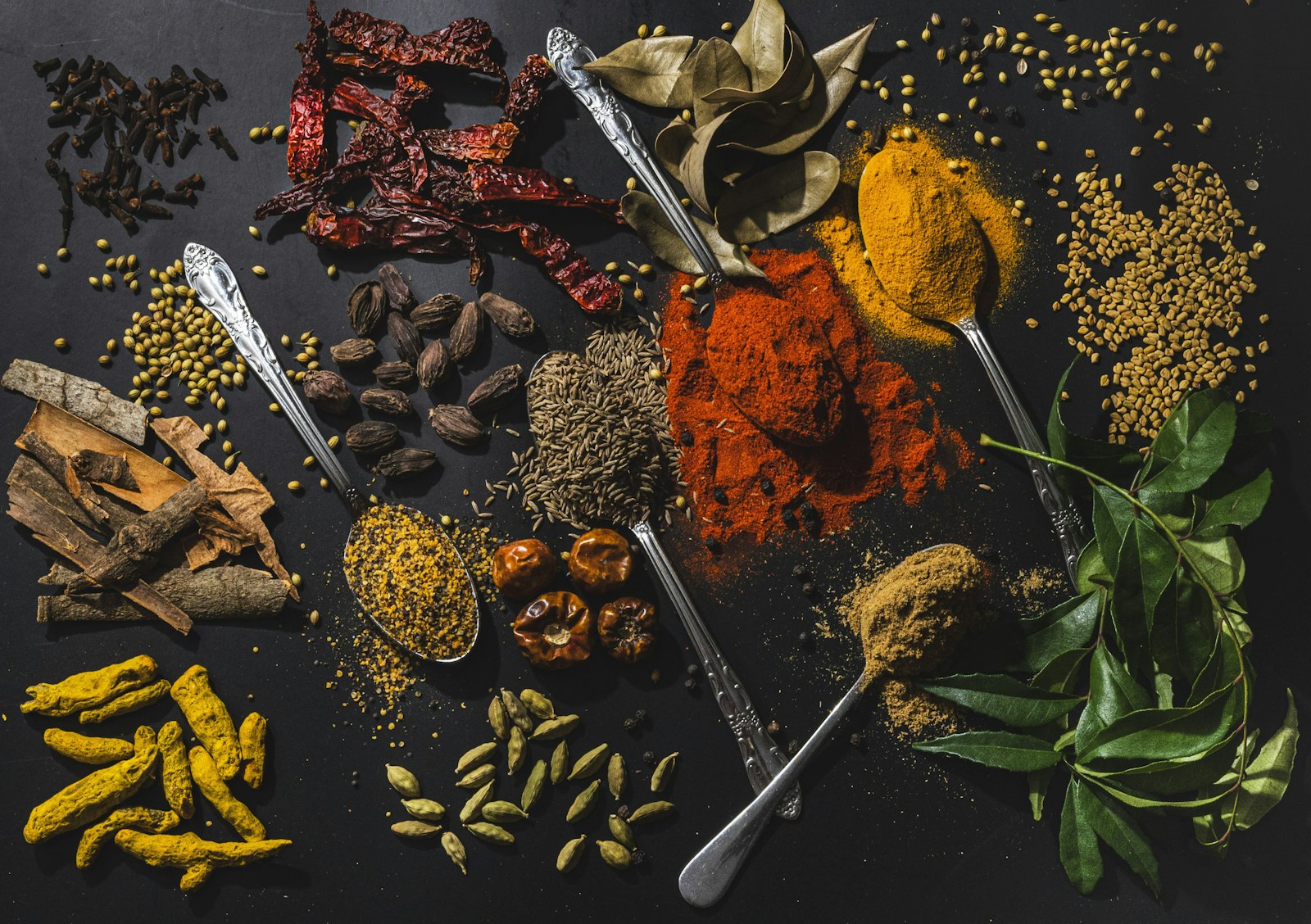 assortiment d'épices variées sur une table, matières premières du parfum épicé