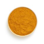 Poudre brune ronde sur surface blanche — curcuma en parfumerie — Noble Essence